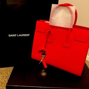 I am Selling a Red Ysl Sac de Jeur bag in Size Small.